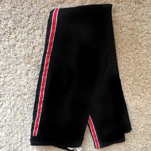 Black skinny jeans with a red strip